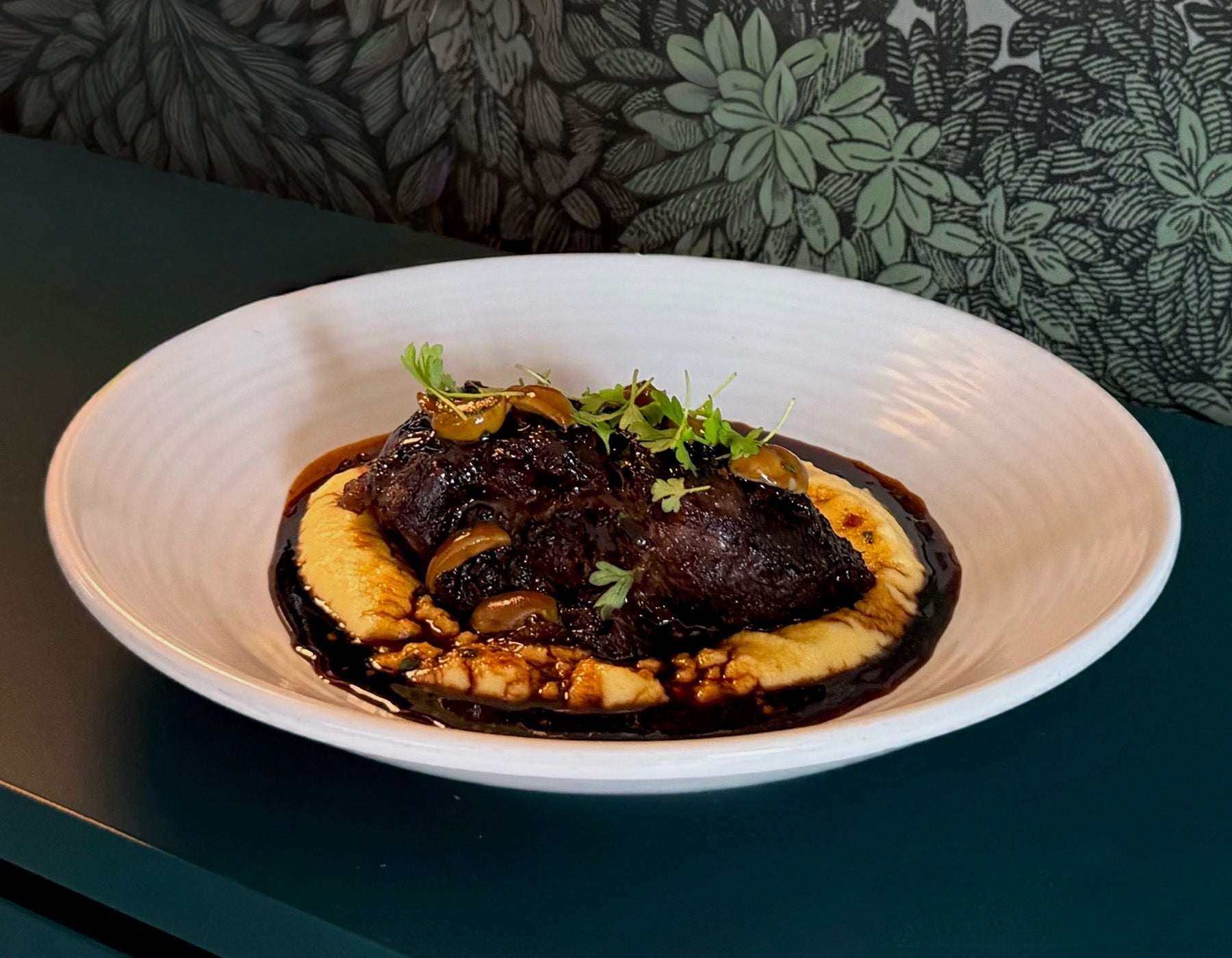 Slow Cooked Beef Cheeks, Creamy Polenta, Green Olives, Red Wine Jus
