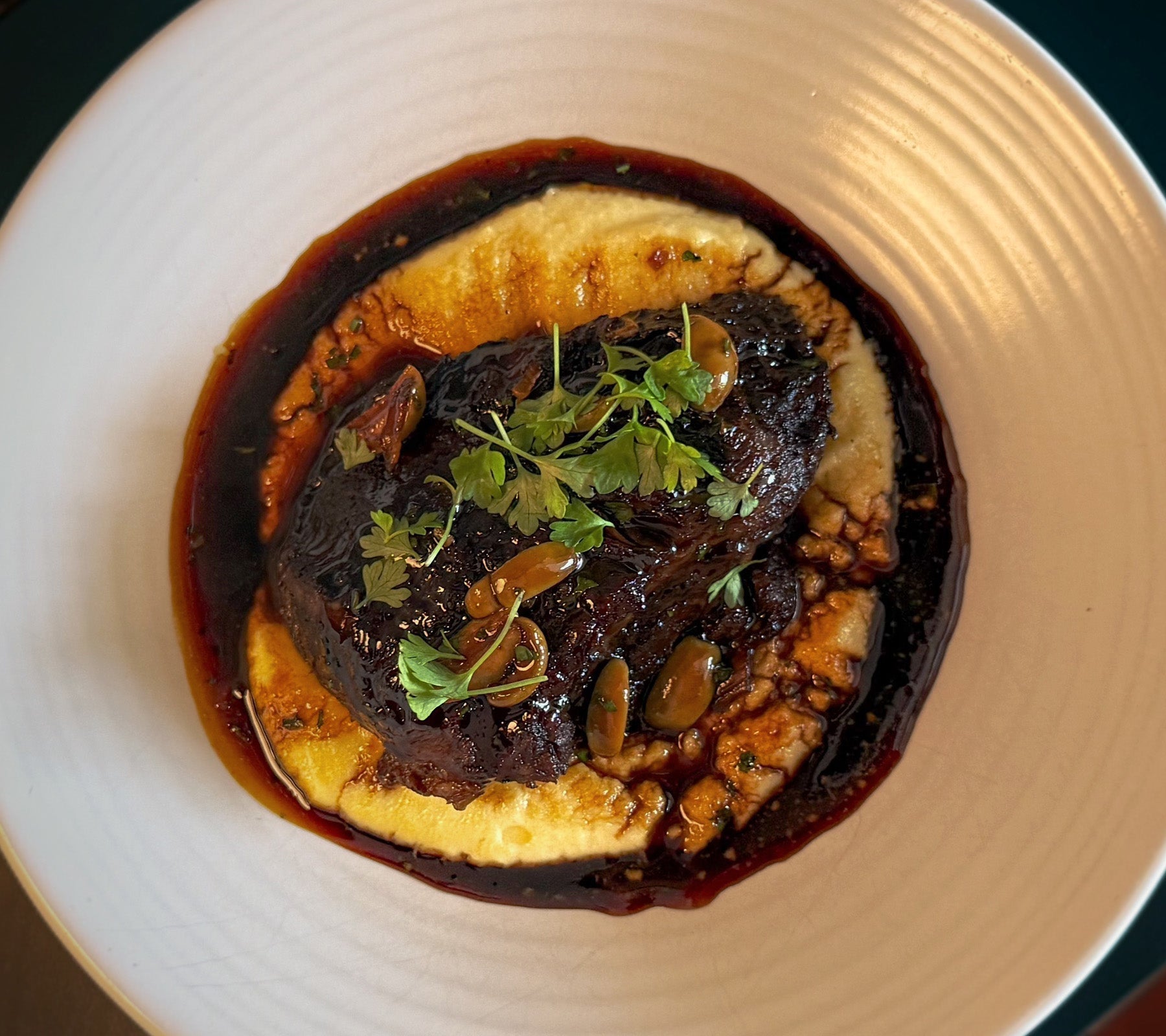 Slow Cooked Beef Cheeks, Creamy Polenta, Green Olives, Red Wine Jus
