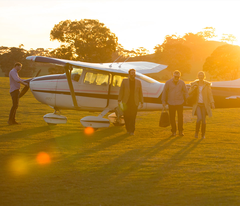 Three people departing a private plane in the Barossa Valley
